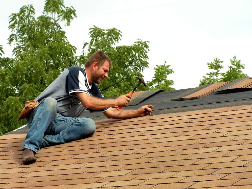 guy fixing roof with hammer, roof, roof replacement, roof replace, roof repair, roof contractor