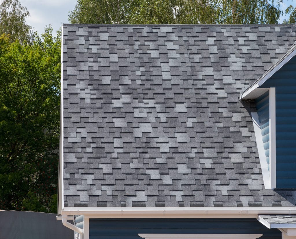 The roof of the house lined with gray bitumen shingles, roof, roofing, roof materials, roofing nails, nails, roof nails, roof replacement, roof repair